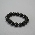 Close-up of polished 14mm black agate beads on an elastic bracelet with high shine - 12mm Black Agate