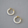 Retro white marble resin hoop earrings with gold metal clasp on grey fabric background - Off White