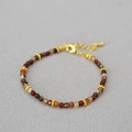 Detail of coffee agate beaded necklace with gold faceted spacers and lobster clasp - Bracelet