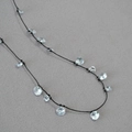 Elegant black cord necklace featuring sparkling zircon flower accents on grey background - Black Leather Cord Style