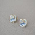 Macro shot of 925 silver camellia earrings with blue enamel and gold-plated borders - Blue and White Flower Stud Earrings