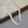 Elegant white beaded choker necklace with gold clasp on wooden display stand - 30+9cm