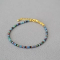 Detail of colorful beaded bracelet with gold lobster clasp and adjustable extension chain - Blue Green Mixed
