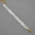 Close-up of hand-woven white square beads necklace with golden lobster clasp and chain - 14+5cm