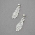 Handmade woven leaf earrings with white seed beads and pearl studs on grey fabric - Silver Stud Earring Style