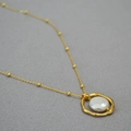 Irregular golden geometric ring pendant with baroque pearl on a beaded satellite chain - Round