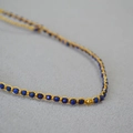 Detailed macro view of handmade Lapis Lazuli beaded bracelet with gold wire weaving - Lapis Lazuli Necklace