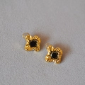Macro view of gold-plated flower stud earring with pleated texture and black zircon - Gold Irregular Flower (Stud Earring)