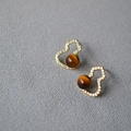 Macro view of gold gourd earrings with sparkling zircons and brown tiger eye stones - Tiger Eye Style