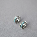 Detailed close-up of silver-plated hoop earrings with turquoise beads and pavé crystals - White Gold