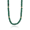Close-up of natural malachite beaded necklace with striped green stones and gold accents - Malachite Beaded Style