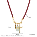 Close-up of leather cord necklace with golden cross, shoe charms and natural stone detail - Wine Red Style (style-3)