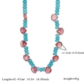 Detail of beaded necklace with sky blue faceted beads and reddish-brown heart gemstones - Blue Beads with Red Heart Pendant (Style 1)