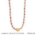 Collier artisanal en perles oranges avec pendentif en forme de cœur doré - Collier Orange
