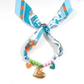 Macro shot of blue floral silk scarf necklace with colorful resin beads and gold heart charms - Heart Beaded Style (11-03-4)