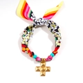 Macro detail of silk scarf necklace with colorful patterns and golden cross pendant - Cross Pendant Style (11-03-1)