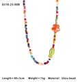 Colorful beaded necklace with orange flower and green fish charms on white background - Orange Flower & Light Green Fish Necklace (DJ10-25-008)