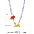 Purple stone bead necklace with a gold M letter pendant and a red crab charm - M