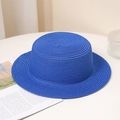 Detailed view of bright blue woven straw hat with flat top texture on white desk - Adult M (56-58cm) / Without Chin Strap / Sapphire Blue