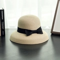 Detail of classic beige straw hat featuring wide black ribbon bow on wooden table - M (56-58cm) / Beige