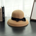 Detailed texture of light brown cloche straw hat with black ribbon bow on wooden surface - M (56-58cm) / Khaki