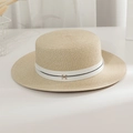 Close-up of woven straw boater hat with a white ribbon and a metal letter M detail - M (56-58cm) / Beige