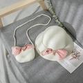 Detail view of a straw hat and matching bag with pink bows and pearl charms for girls - Cream