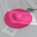Detail view of woven oversized brim straw sun hat in vibrant rose pink color - M (56-58cm) / Rose Red