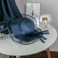 Detail of navy blue straw sun hat featuring a sheer organza brim and inscribed bow ribbon - M (56-58cm) / Navy Blue