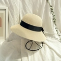 Elegant beige straw sun hat with a wide black ribbon bow on a modern wire hat stand - Beige (Adult)