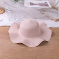 Detail of light pink straw hat with wavy brim on wooden surface with mesh decor - M (56-58cm) / Solid Edge Wavy - Pink