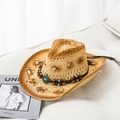 Detail of hollow-out straw cowboy hat with turquoise bead band on a textured sofa - M / Khaki