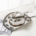 Western style white straw cowboy hat with turquoise bead band on a minimalist sofa - M / White