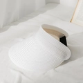Close-up of white straw sun hat weave texture with black elastic band on white fabric - M / White