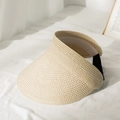 Detail of hand-woven straw sun visor with adjustable black strap on white fabric - M / Beige
