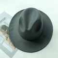 Detail of dark grey wide-brimmed felt fedora hat with decorative stitch and magazine prop - Kids / Gray