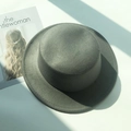 Detailed top view of a dark grey flat-top wool felt boater hat with a fashion magazine - M (56-58cm) / Gray