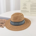 Detail of bohemian straw fedora hat featuring ethnic geometric pattern band on white table - M (56-58cm) / Khaki