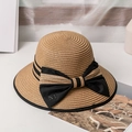 Detail of elegant straw hat with black grosgrain bow and metal letter M emblem - M / Khaki