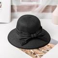 Macro detail of black straw sun hat featuring a satin bow and metallic M letter charm - M / Black