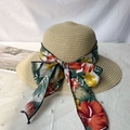 Close-up of woven straw hat featuring a tropical floral ribbon and bow detail - M / Beige