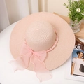 Detailed macro shot of the pink straw hat with a chiffon bow and pearl chain accents - M (56-58cm) / Pink