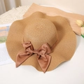 Women's wide brim woven straw hat with brown ribbon bow and wavy rim for sun protection - M / Khaki