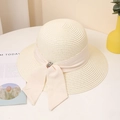 Detailed close-up of cream woven straw hat featuring a wide ribbon bow and colorful gemstone - M / Milk White