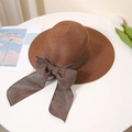 Detailed texture of brown straw sun hat with large bow on white pedestal - M (56-58cm) / Coffee