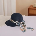 Close-up of dark blue woven straw sun hat with floral bow ribbon and detailed texture - M (56-58cm) / Navy Blue