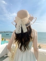 Detail of pink straw sun hat featuring a wavy lace mesh brim and large elegant bow tie - M (56-58cm) / Nude Pink