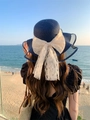 Detail of navy straw sun hat featuring a large lace bow and elegant pearl accents - M (56-58cm) / Navy Blue