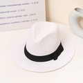 Close-up of white woven straw fedora with a black ribbon bow on a minimalist surface - M (56-58cm) / Bleached White