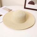 Detail of fine spiral weave and edged brim on a beige wide-brim straw sun hat - M (56-58cm) / Beige